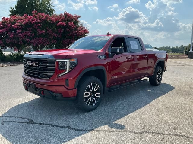 2023 GMC Sierra 1500 AT4 in Volcanic Red Tintcoat — front three-quarter view